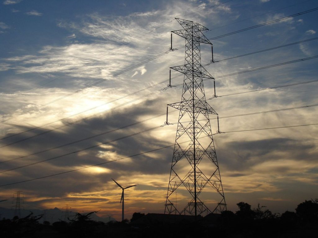Sustainable Bonds Face Tougher Verification Standards Wind turbines in a green field